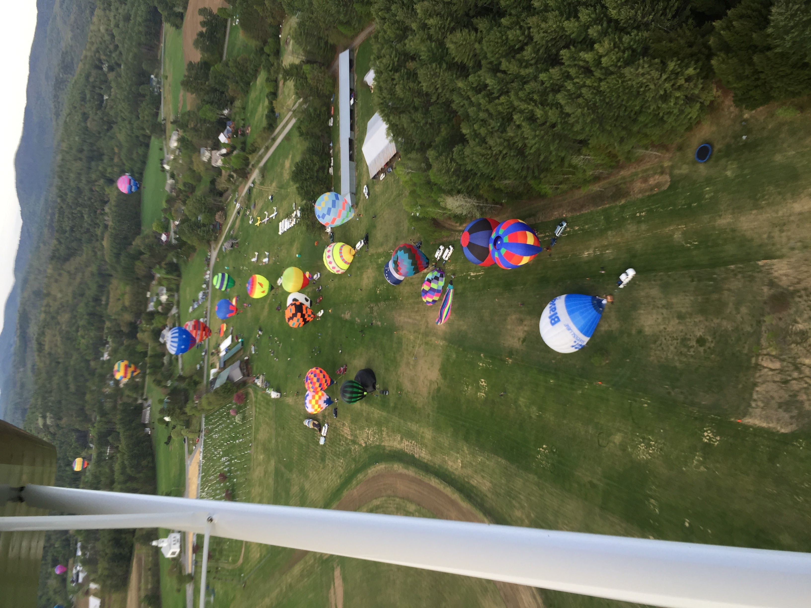Hot air balloons launching from Post Mills Airport, viewed from above